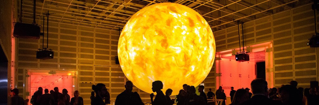 Glowing 3D sun lights up a room with a crowd