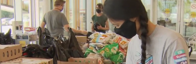 People packing food hampers for those in need.