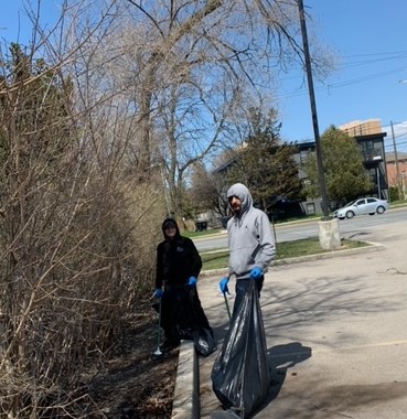 Image of clients at the 1677 Wilson Avenue shelter participating in a community clean-up