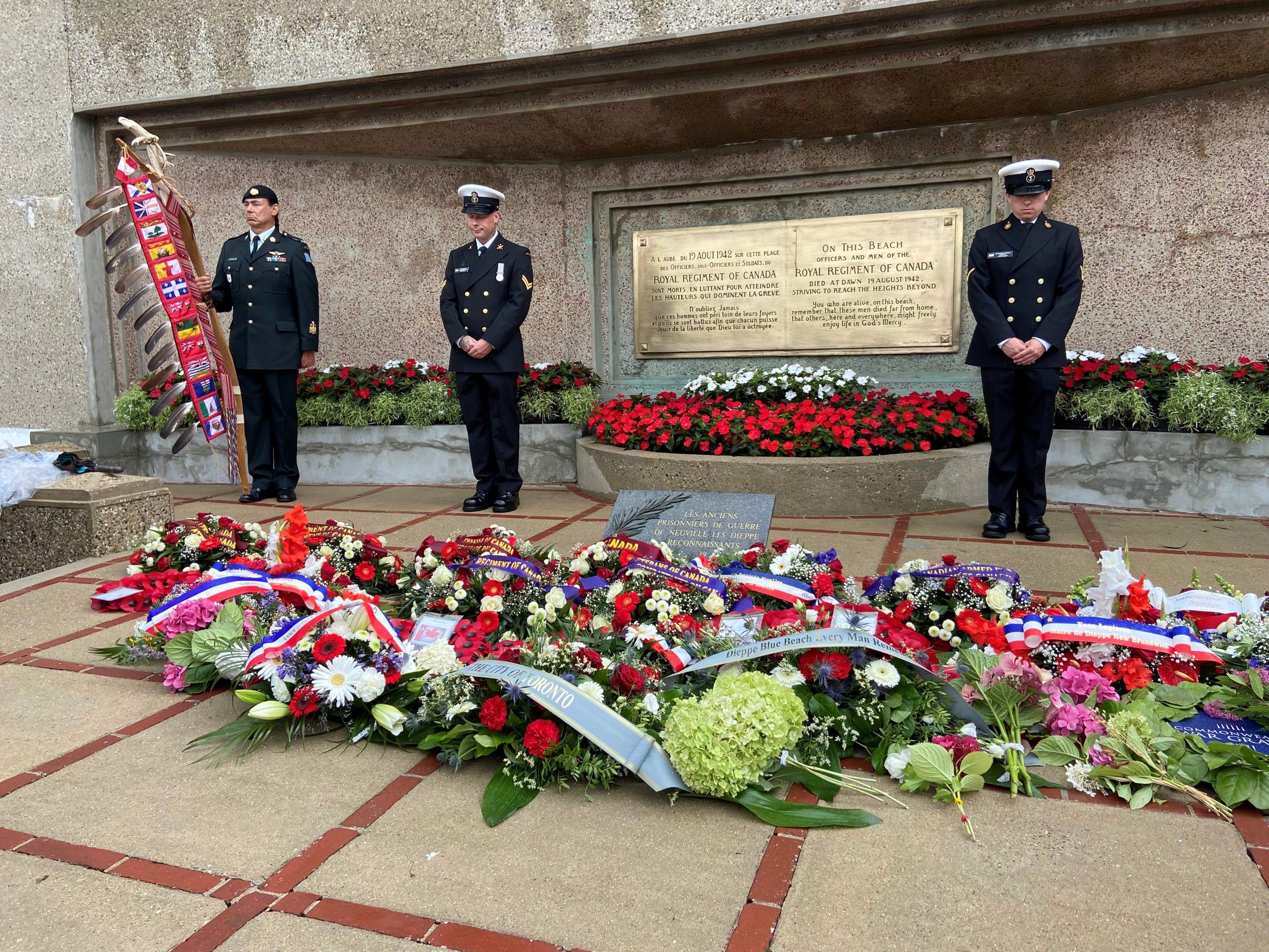 A group of wreaths, with the City of Toronto wreath in front, are seen in front of the Canada memorial in Dieppe, France.