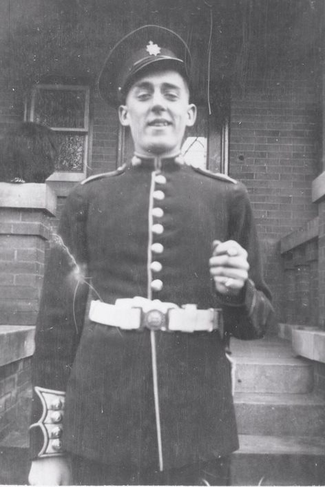 Black and white portrait of Private Charles Surphlis in front of 5 Selby St Toronto