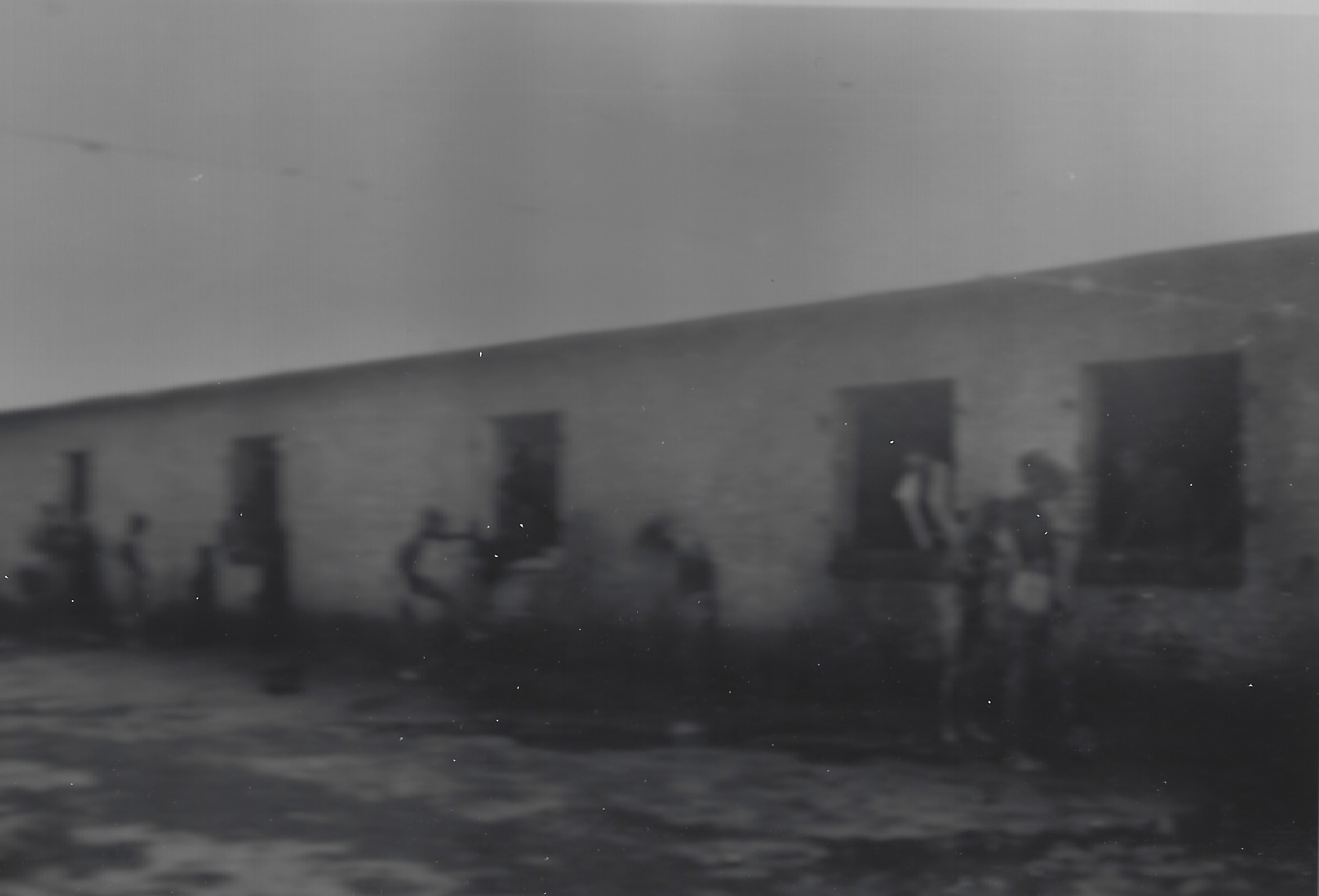 Image of prisoners of war showering in the rain