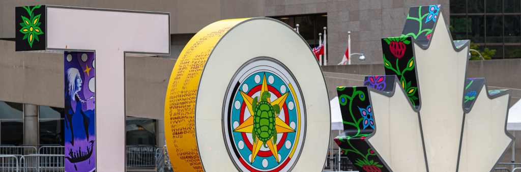 Letters T and O and Maple Leaf of the Toronto Sign with wrap artwork entitled Rekindle