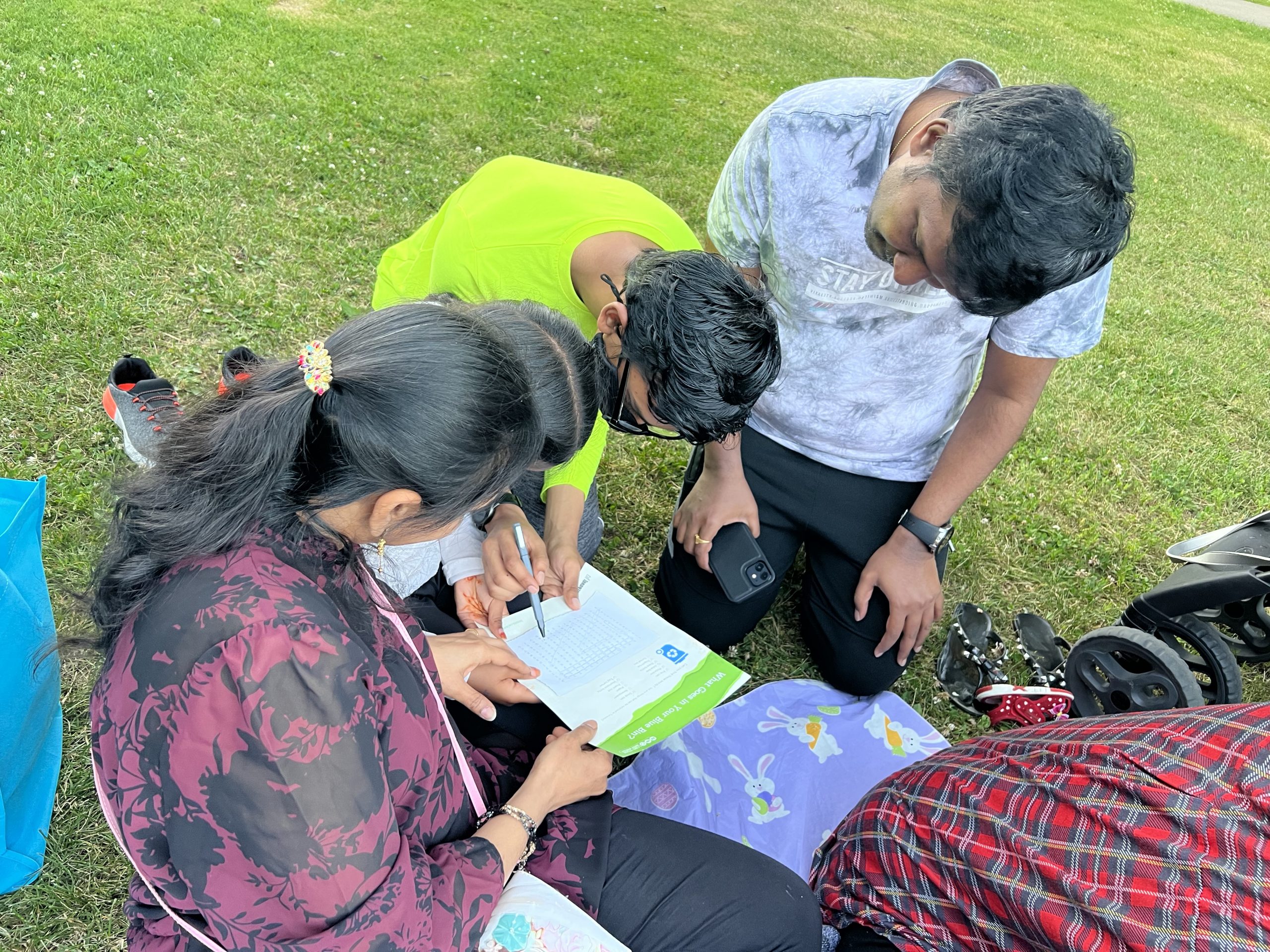 A family filling out an environmental knowledge quiz.