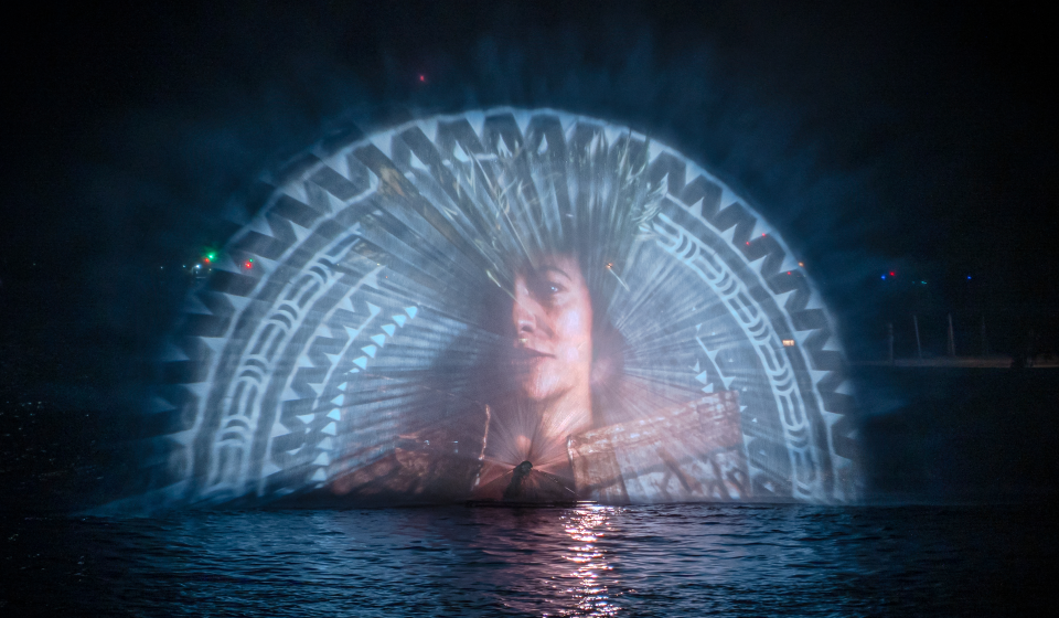 Video installation of a portrait and pattern projected onto a water screen.
