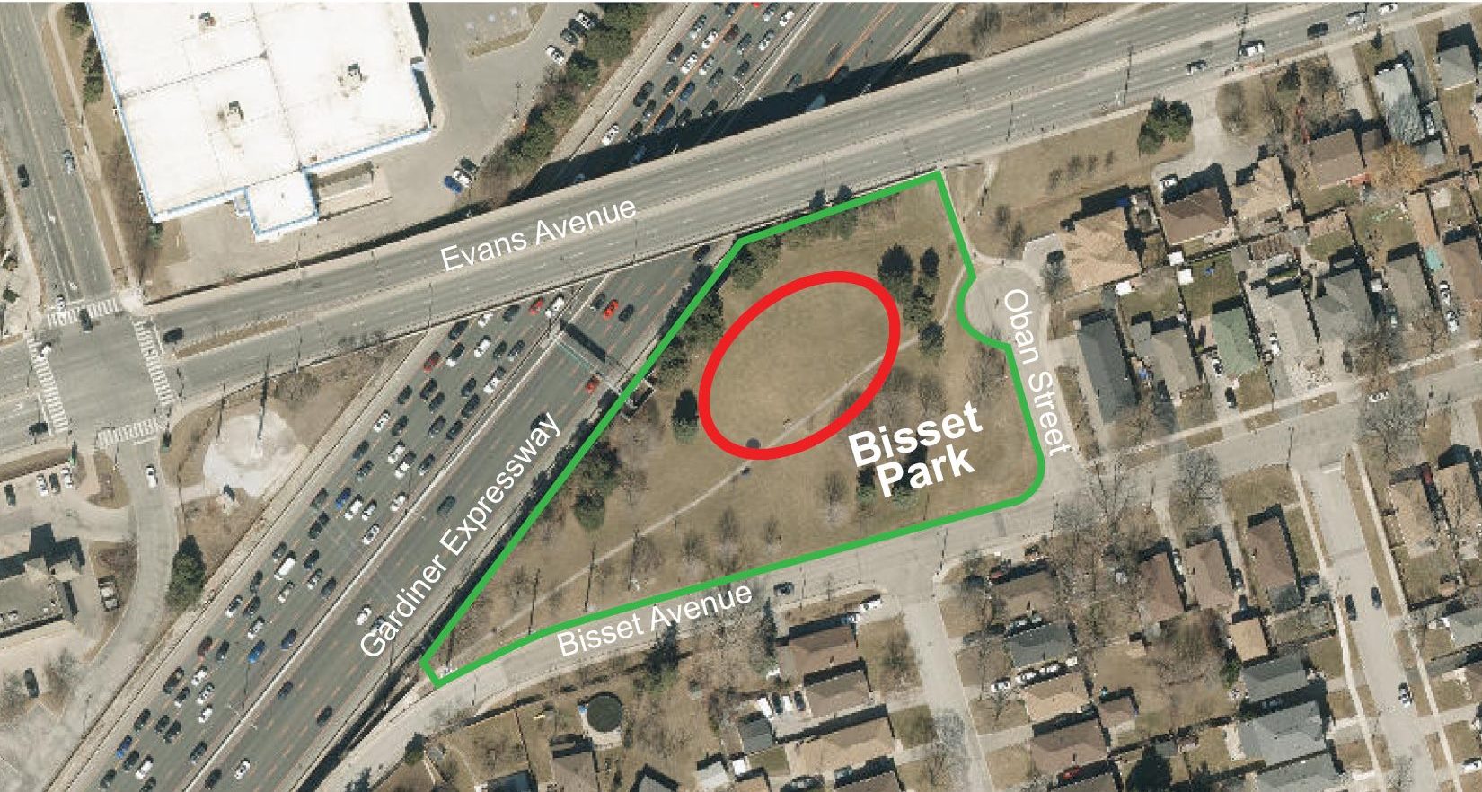 An aerial map of Bisset Park and the surrounding area, with shows the park boundaries outlined in green, and the location of the new dogs off-leash area with a red circle, at the centre of the park. 