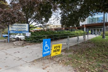 exterior of polling place showing vote here signs