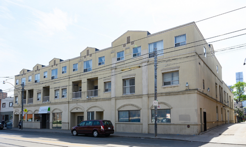 A photo showing an exterior view of the building at 292-296 Parliament St. It’s beige building that has three stories.