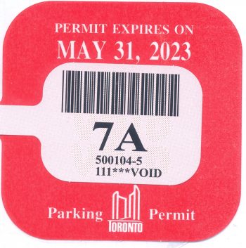 2022-2023 Parking Permit Sticker which is red and reads Permit Expires on May 31, 2023.