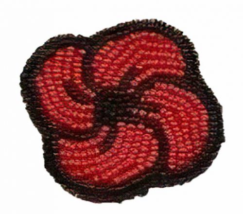 A photo of a red and black poppy made of beads.