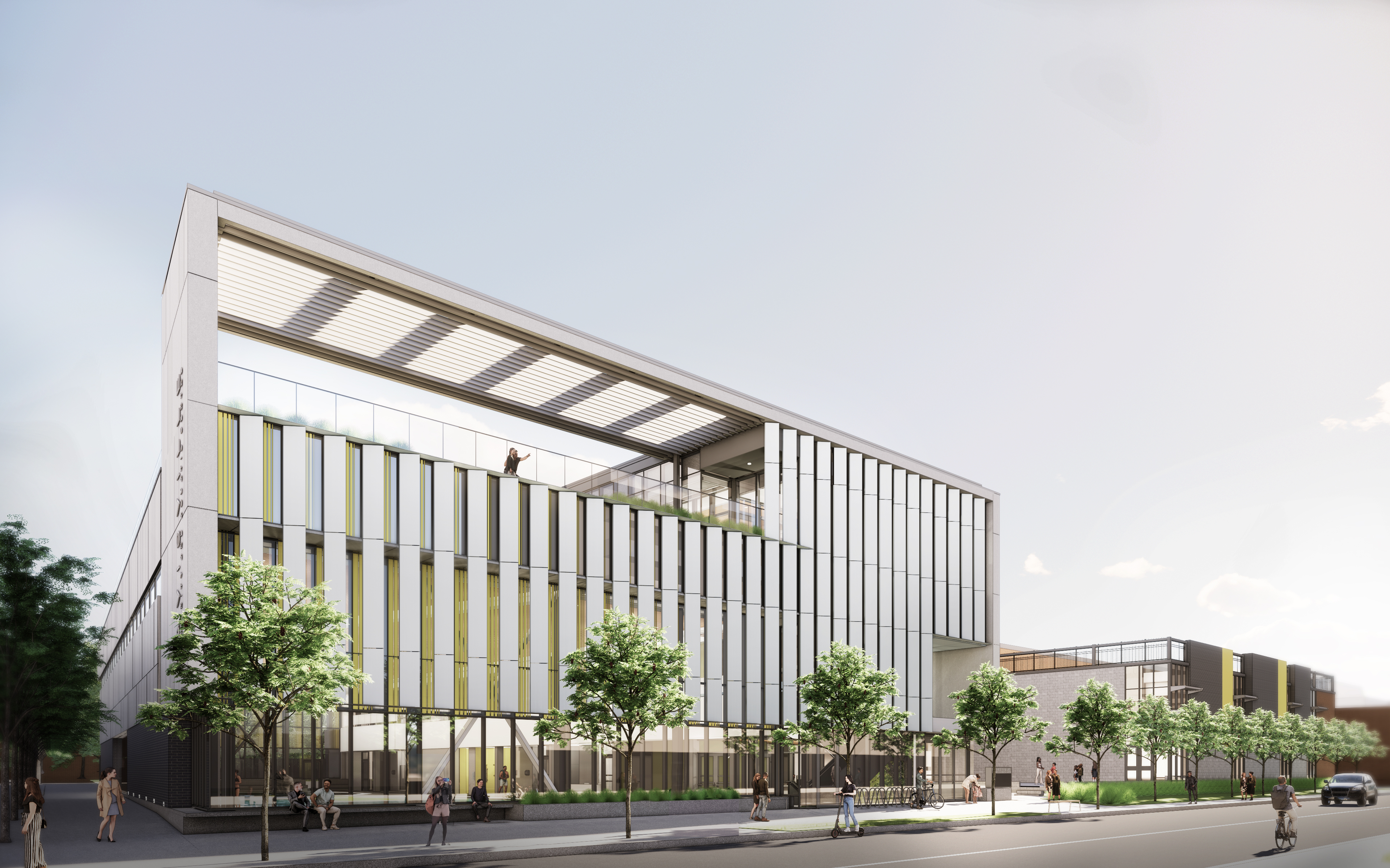 A rendering of the new centre, view facing northeast, from Davisville Avenue. The building is three stories tall. The first/main floor is predominately a glass façade, with the main entrance on the south-east corner of the building and bicycle parking near the entrance. The second and third floors have light coloured vertical panels along the south façade. The third floor includes an accessible rooftop area, which is visible from the street level and includes plantings along with a pergola along the south façade.