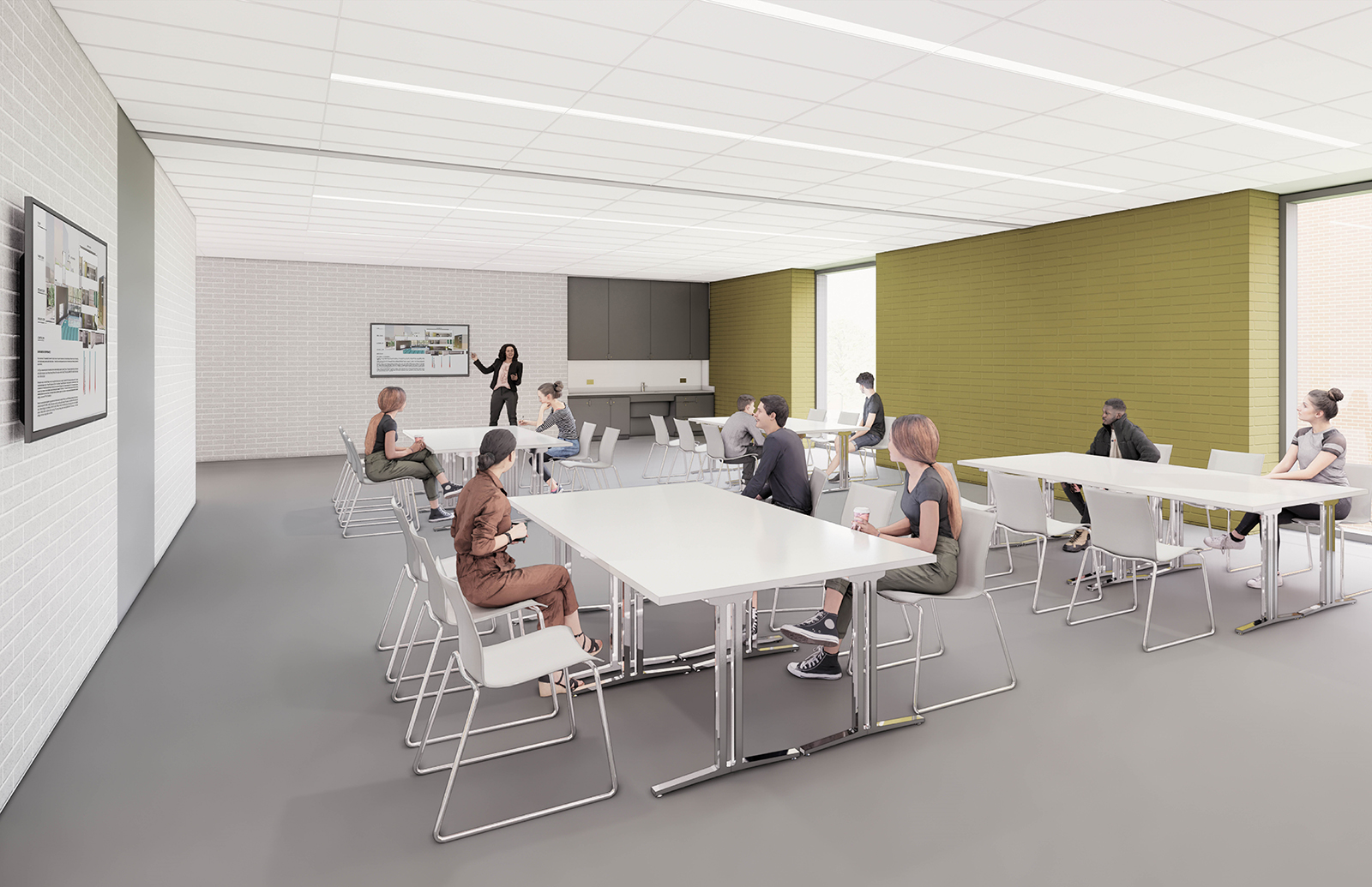 A rendering of a multi-purpose room, set up with tables and chairs in the centre. There is a sink with cupboard storage space on the back wall. On the left and back walls there are large computer screens. There are two large floor to ceiling windows on the right wall. In this rendering, a staff member is teaching a course to participants.