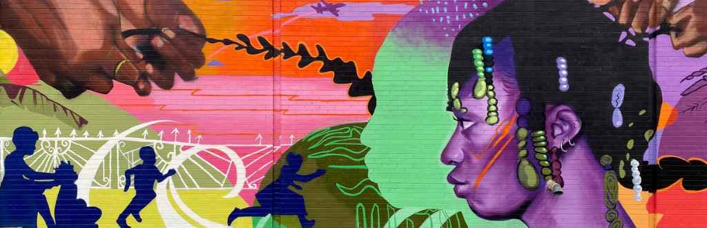 Mural in vibrant purple, teal and warm tones with a side view of a Black female with purple-toned skin having her hair styled in the foreground. Abstract colourful shapes fill the background behind her.