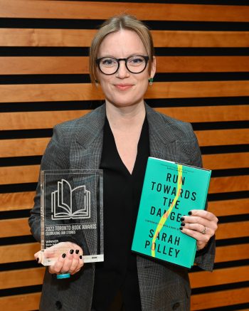 2022 Toronto Book Award winner Sarah Polley displays her trophy and winning book, Run Towards the Danger