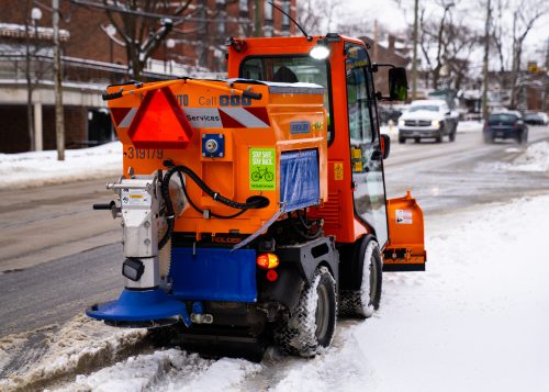 sidewalk plow dispersing salt