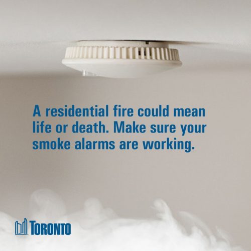Smoke alarm on ceiling with text and smoke below