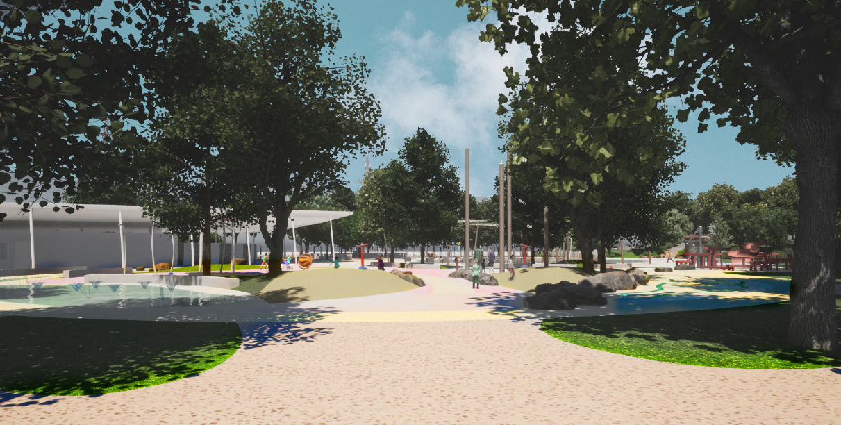 Rendering of the southern Splashpad Area shows the junior splash pad on the left with gentle water features for younger visitors. The centre pathway leads to the senior splash pad (with bucket dump) and pavilion. On the left is the cognitive play area. There are trees throughout the site. The view is from the southwest of the park looking north.