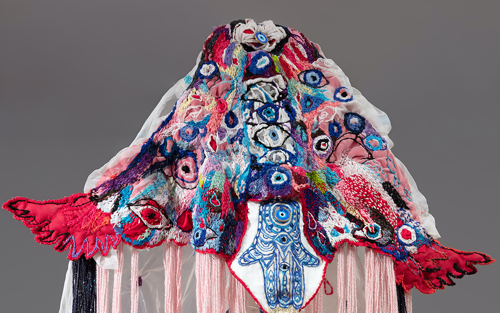 Image of a pink, blue and red veil on display