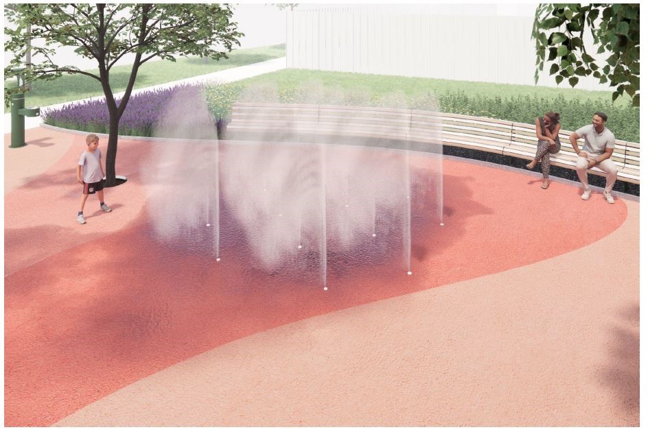 A rendering of Splash Pad Option A, showing vertical in-ground water jets in the centre of the image, spraying water upwards. There is a water puddle under the jets. To the left is a child under a tree, playing in the water jets. Further left is a green drinking fountain and bottle filler. Behind and to the right of the jets is a long wooden bench with a back. Two people are sitting on the bench watching the child play. Under the splash pad is a colourful rubberized surface.