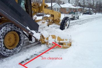 windrow clearing machine clears a three metre section of a driveway opening.