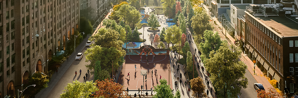 A conceptual rendering of the park, viewed from above and looking west toward the downtown area. The design highlights the park’s central pathway lined by lush trees and revitalized amenities, including a basketball court. People are walking, gathering and playing throughout the park. Buildings and roads border the park on both sides.