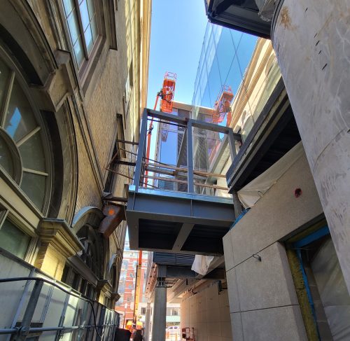A glass bridge linking to St. Lawrence Market being installed.