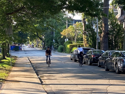 People cycling in both directions on Gladstone Avenue between College Street and Dundas Street West