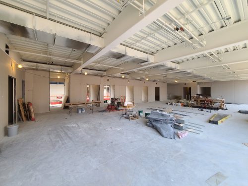 An office at St. Lawrence Market, North Building under construction showing overhead lights, construction tools and an unfinished floor.