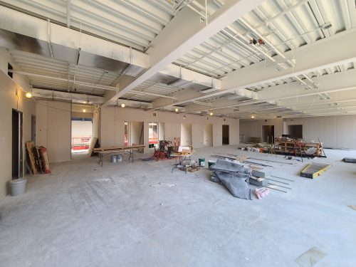 An office at St. Lawrence Market, North Building under construction showing overhead lights, construction tools and an unfinished floor.