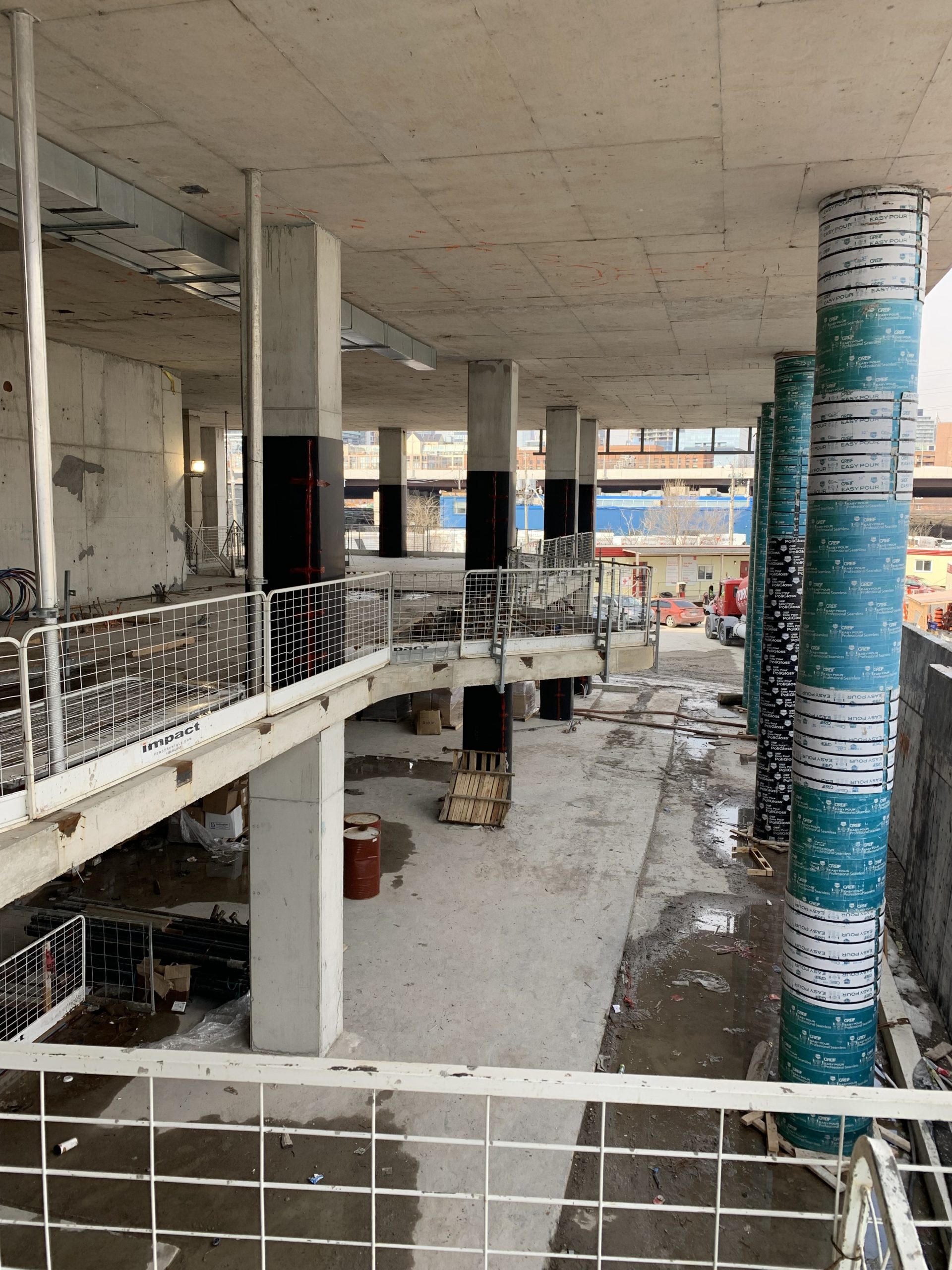 Photograph of the construction for the new East Bayfront Community Recreation Centre, showing the construction of the second floor overlooking the lobby in concrete.