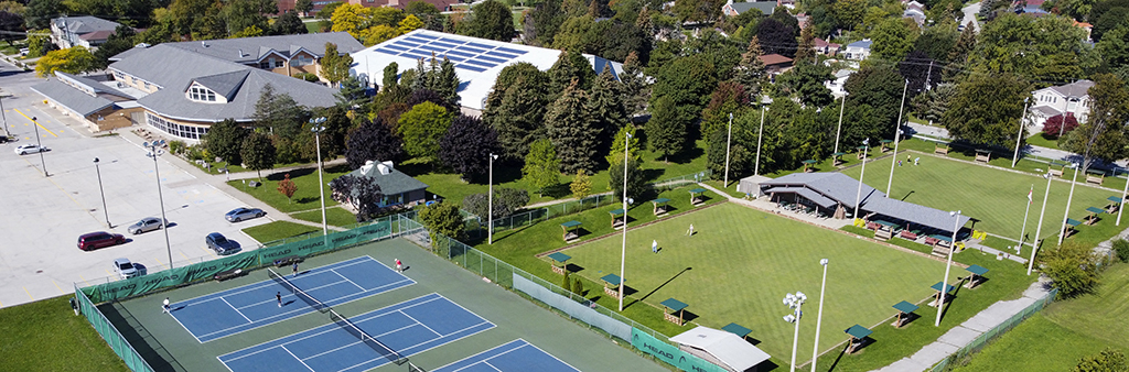 Arial photograph of Agincourt Community Recreation Centre with outdoor tennis courts and lawn bowl greens beside the Centre.