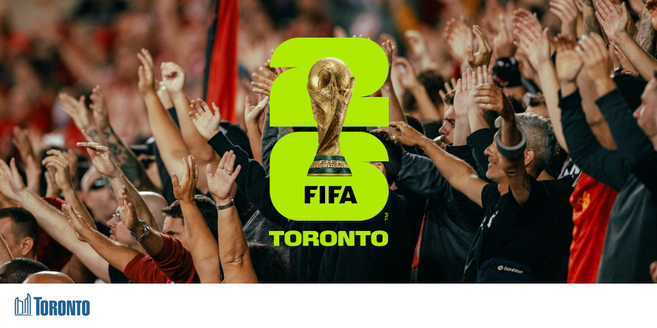 Hands in a crowd raised in the air with FIFA Toronto logo