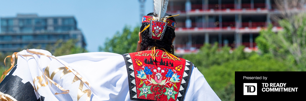 Back of a fancy shawl dancer. Words presented by TD Ready Commitment