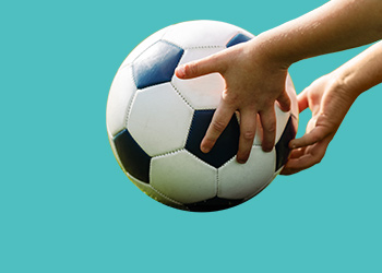 Person holding a soccer ball in both hands