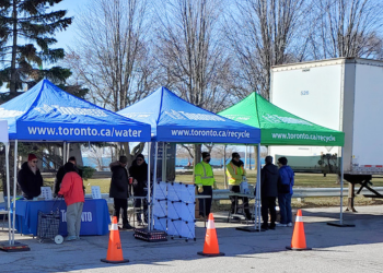 People attending tented booths at a Community Environment Day event