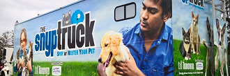 A branded mobile veterinary clinic, the "Spay-Neuter Your Pet” truck