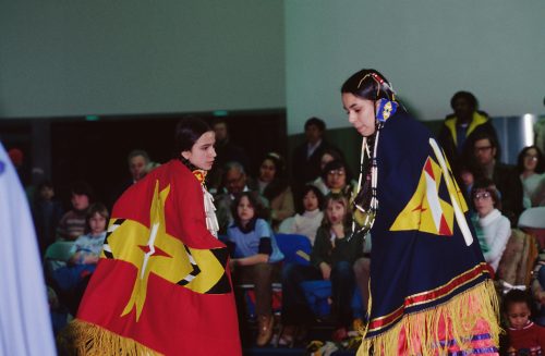Image depicts two Indigenous females in traditional costume