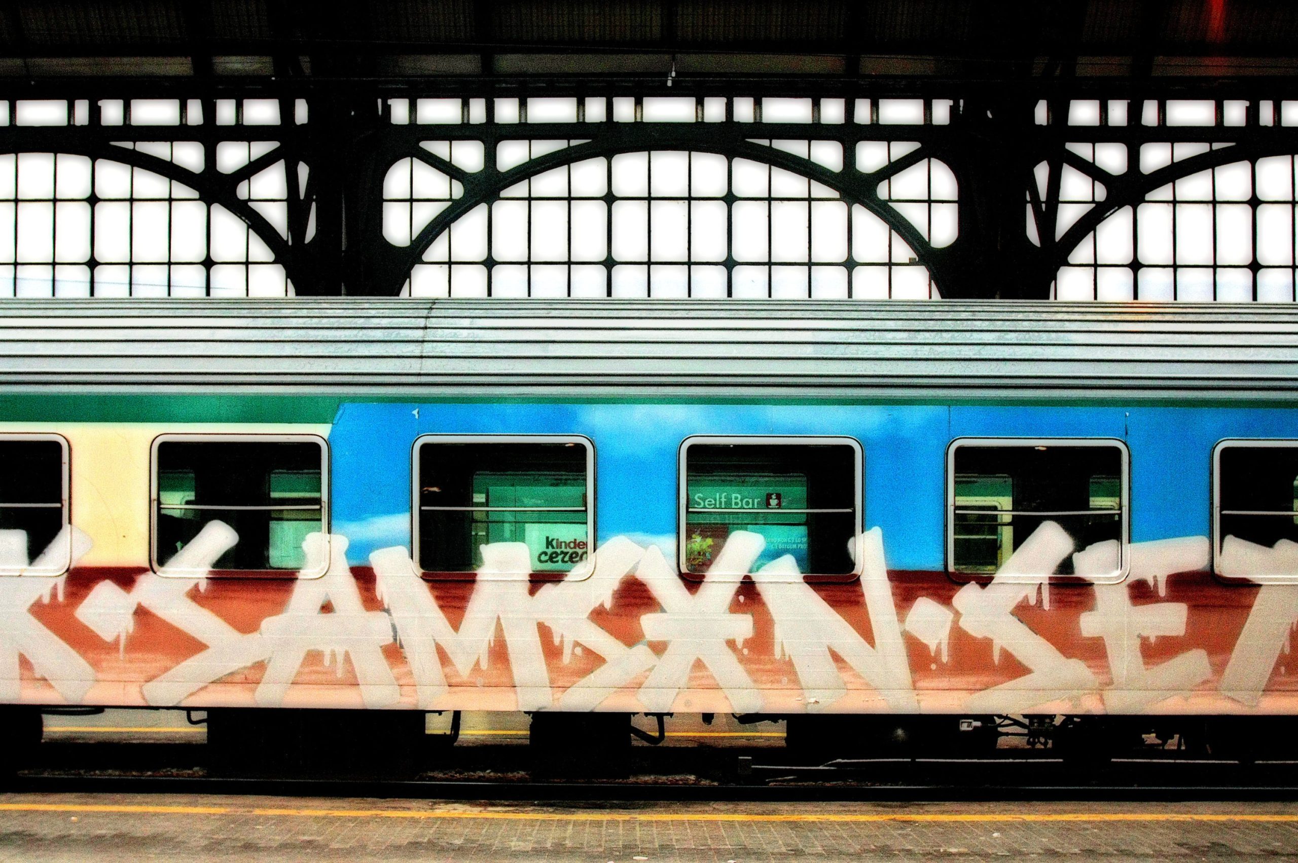 Train car covered in graffiti within a train station