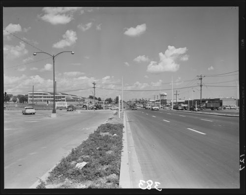 Image depicts six lane boulevard taken from central reservation