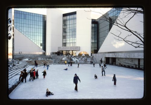 Image depicts people ice skating on outdoor rink