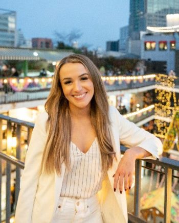 Katie Heggtveit wearing a white sweater, smiling.