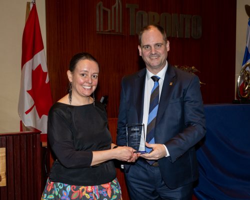 Selina Young and Paul Johnson holding City Manager's Award