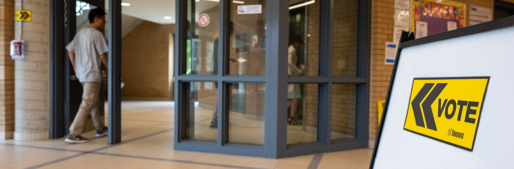 Image of a person walking into a voting place