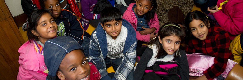 Group of children smiling up at camera