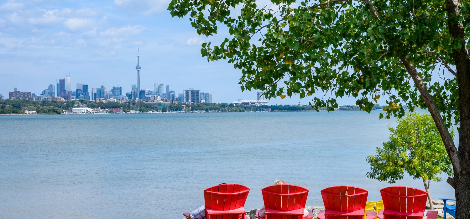 Waterfront observation point with colorful chairs & vistas of Humber Bay & the city skyline.