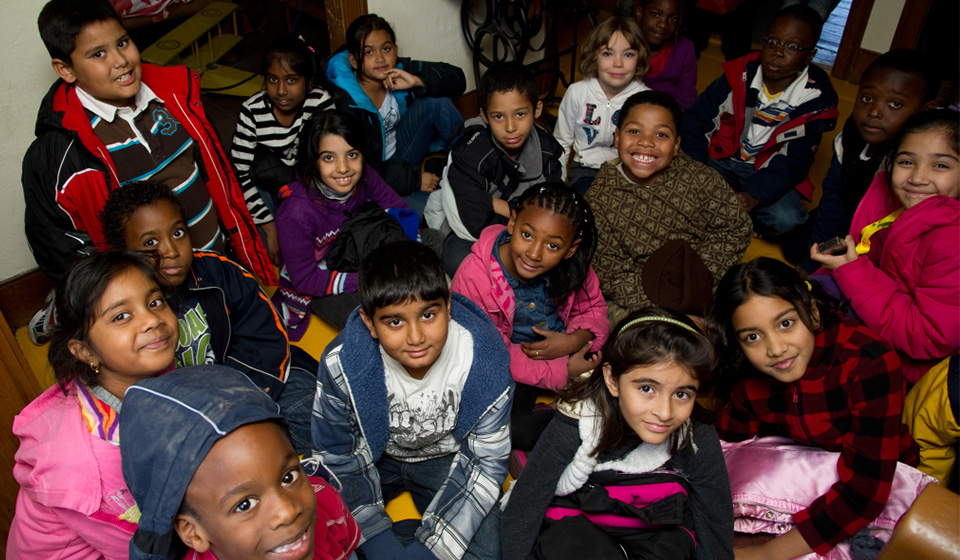 Group of children sitting looking up at the camera and smiling