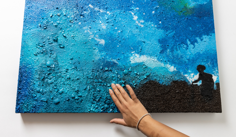 Textured painting being touched by outstretched hand