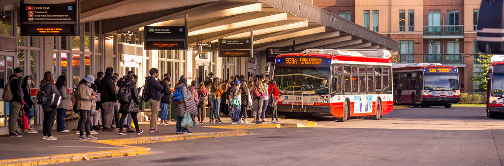 People waiting for busses at a TTC bus station