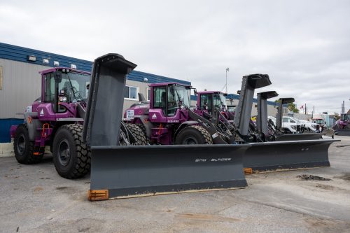 various snow removal machines parked at a holding yard