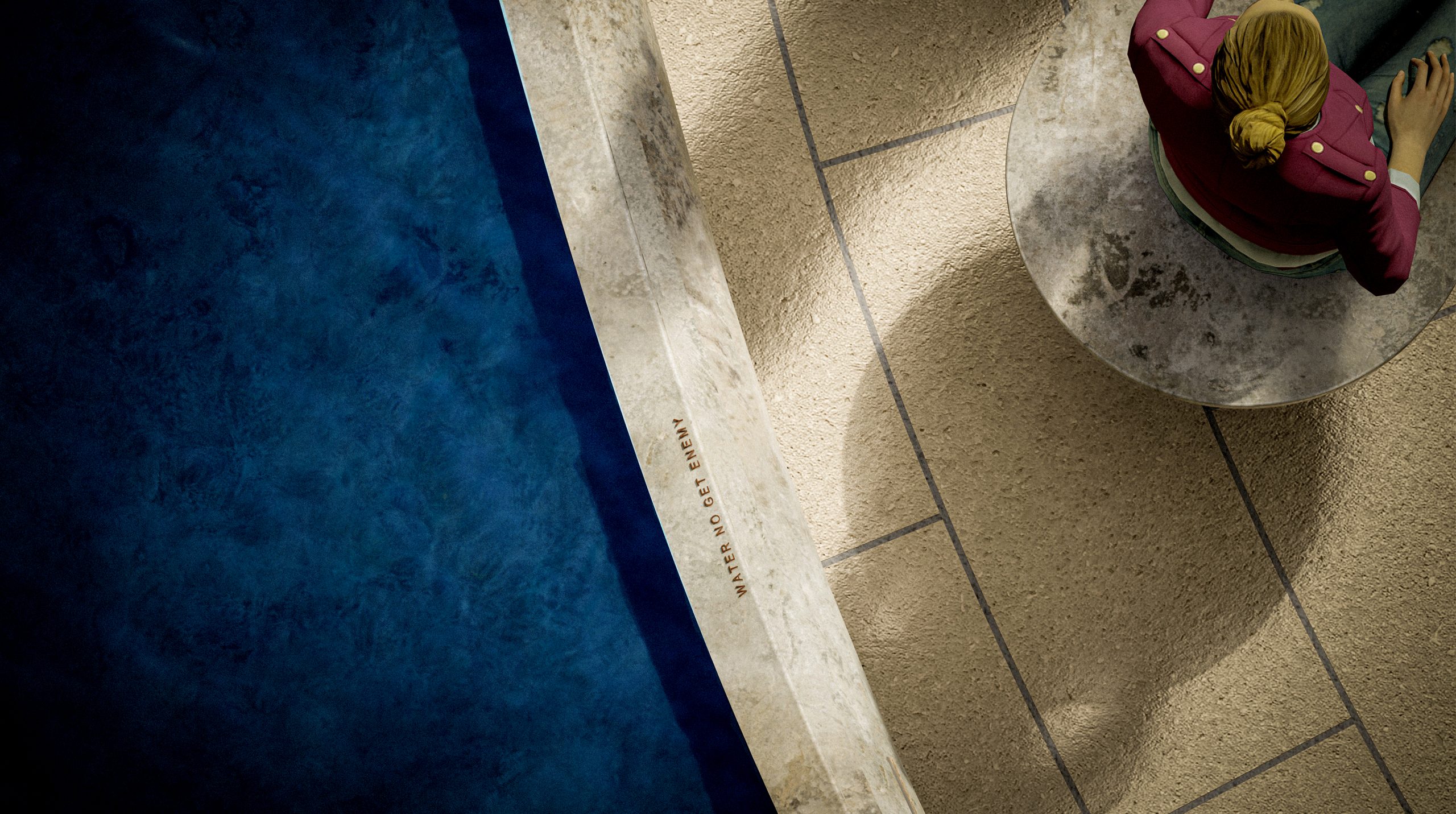 A zoomed-in view shows the edge of the water feature, the stone edging of the feature, as well as the radial paving next to the feature. Next to the water feature you can see that someone is sitting on a stone stool. On top of the stone water feature edging is an inscription of a Fela Kuti quote: “Water No Get Enemy”.